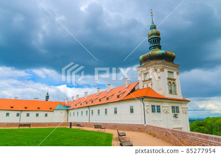 Jesuit College building, green grass lawn and benches Jesuit College building, green grass lawn and benches 85277954