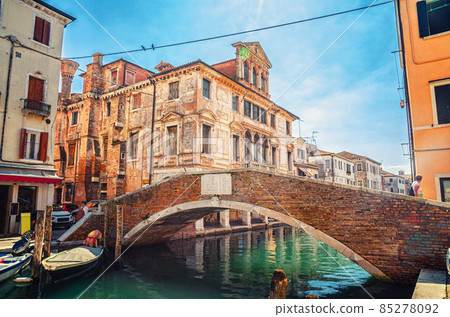 Stone brick bridge Ponte Caneva across Vena water canal in historical centre of Chioggia Stone brick bridge Ponte Caneva across Vena water canal in historical centre of Chioggia 85278092