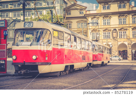 Typical old retro vintage tram on tracks near tram stop in the streets of Prague Typical old retro vintage tram on tracks near tram stop in the streets of Prague 85278119