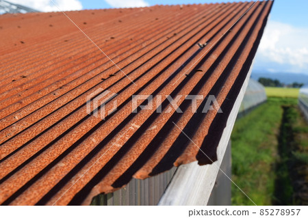 Reddish brown rusted corrugated iron 85278957