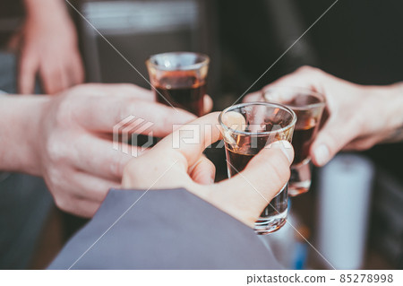 Three friends toast to health and drink liquor Three friends toast to health and drink liquor 85278998
