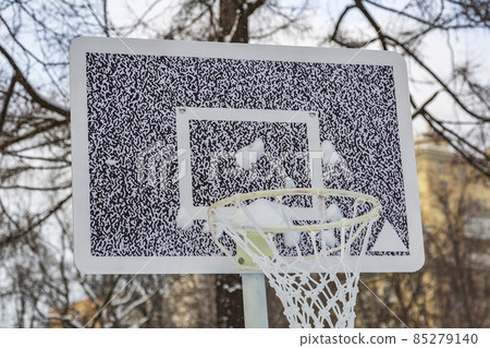 Basketball backboard and basket in snowy winter park 85279140