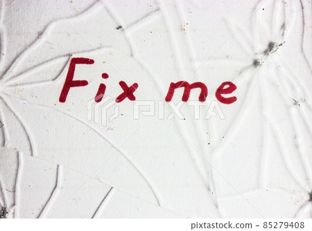 Broken protective glass with cracks damage on display on white background with red letters text Fix me. Need for warranty repair of tempered glass for smartphone touchscreen concept. 85279408