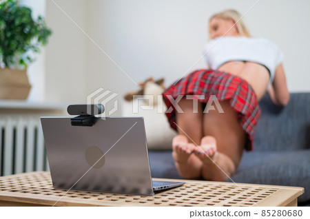 Faceless young woman dressed in schoolgirl costume for online sex. The web model is dancing twerk to the camera 85280680