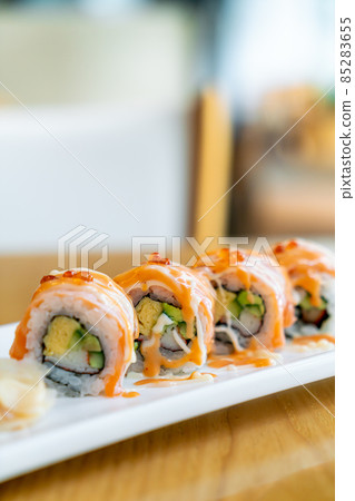 salmon roll sushi with sauce on top 85283655