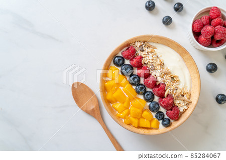 homemade yogurt bowl with raspberry, blueberry, mango and granola homemade yogurt bowl with raspberry, blueberry, mango and granola 85284067