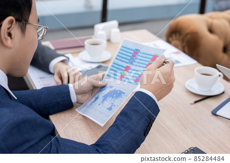 Hand of young businessman pointing at financial data 85284484