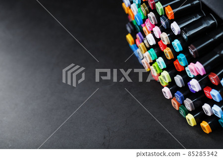 Professional sketching markers of different colors in a bag on a dark table. Professional sketching markers of different colors in a bag on a dark table. 85285342