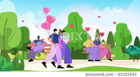 loving couple celebrating happy valentines day in park man woman in love standing together with flowers and pink air balloons loving couple celebrating happy valentines day in park man woman in love standing together with flowers and pink air balloons 85285683