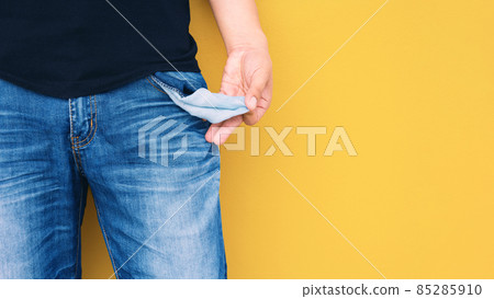 Man showing his empty pocket on yellow wall background. Man showing his empty pocket on yellow wall background. 85285910