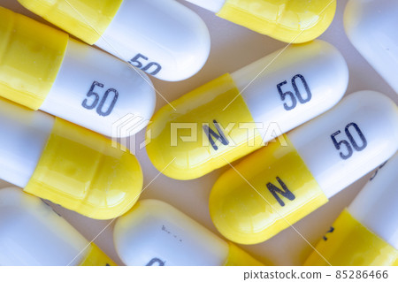 A macro close up to white and yellow N 50 capsules 85286466