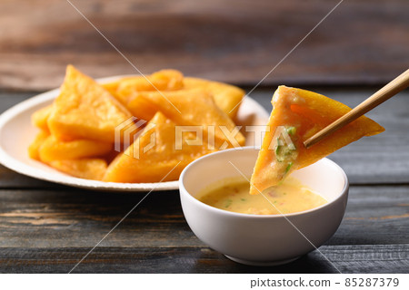 Deep fried Burmese tofu eating with spicy dipping sauce, Tai Yai food in Northern of Thailand 85287379