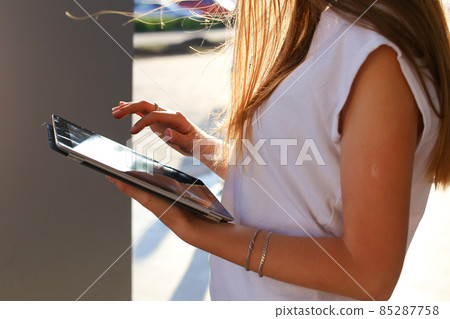 Woman browsing tablet in business center Woman browsing tablet in business center 85287758