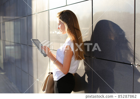 Woman browsing tablet in business center 85287862
