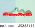 The curved pop tube stands leaning against the wall. Modern still life with antistress toy 85288132