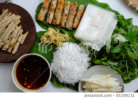 Vietnamese homemade vegan food, fried spring rolls with bun herbal leaf and rice paper Vietnamese homemade vegan food, fried spring rolls with bun herbal leaf and rice paper 85289132