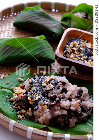 Vietnamese homemade black bean sticky rice with sesame salt for cheap and quick breakfast in green leaf Vietnamese homemade black bean sticky rice with sesame salt for cheap and quick breakfast in green leaf 85289143