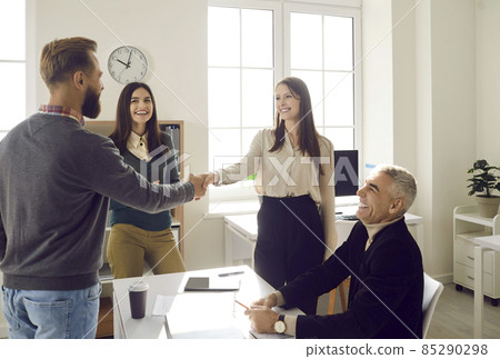 Two business people exchanging handshake after successful work meeting in office. Happy businessman shaking hands with manager, credit adviser, financial agent, or insurance company representative 85290298