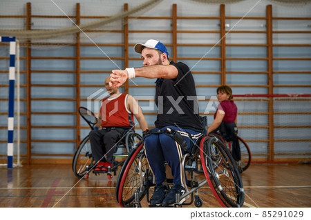 People in wheelchair playing tennis on court. Wheel Chair Tennis For Disabled. People in wheelchair playing tennis on court. Wheel Chair Tennis For Disabled. 85291029