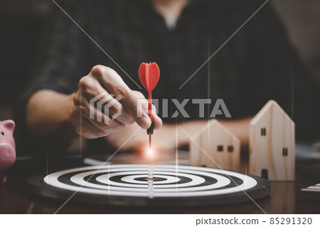 Targeting the business concept, Businessman touch red arrow dart to the virtual target dartboard, Executive marketing, investment goal and target for business investment concept, mini home. 85291320
