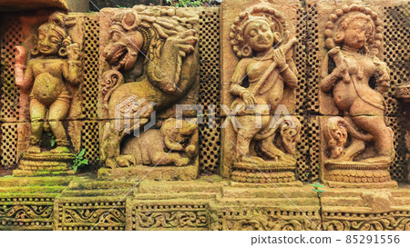 Sukasari Temple wall built in sandstone with carvings of human figures, deities, scroll work and floral motifs on walls. Bhubaneswar, Odisha, India. Sukasari Temple wall built in sandstone with carvings of human figures, deities, scroll work and floral motifs on walls. Bhubaneswar, Odisha, India. 85291556