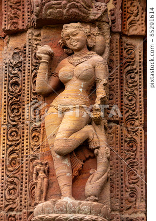Sculptures of maidens clutching trees/foliage on walls of the Rajarani temple. 11th century Odisha style temple constructed dull red and yellow sandstone, Bhubaneswar, Odisha, India. Sculptures of maidens clutching trees/foliage on walls of the Rajarani temple. 11th century Odisha style temple constructed dull red and yellow sandstone, Bhubaneswar, Odisha, India. 85291614
