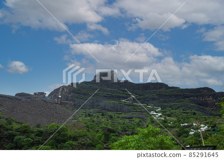 Mangi Tungi hill and stairs leading to the top, Mangi Tungi, Nashik, Maharashtra, India. Prominent twin-pinnacled peak with plateau in between. Mangi Tungi hill and stairs leading to the top, Mangi Tungi, Nashik, Maharashtra, India. Prominent twin-pinnacled peak with plateau in between. 85291645