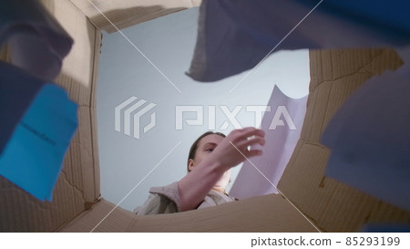 Photo of woman throwing teared paper, bottom view Photo of woman throwing teared paper, bottom view 85293199