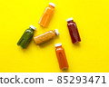 Fresh juices or cocktails of fruits and vegetables in bottles on a yellow background. The concept of a healthy diet or diet 85293471