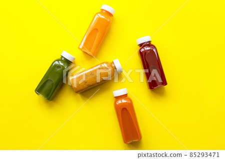 Fresh juices or cocktails of fruits and vegetables in bottles on a yellow background. The concept of a healthy diet or diet Fresh juices or cocktails of fruits and vegetables in bottles on a yellow background. The concept of a healthy diet or diet 85293471