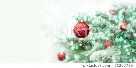 Beautiful Christmas tree outdoor with pink xmas balls, snow, lights bokeh around, and snow falling, Christmas atmosphere. Beautiful Christmas tree outdoor with pink xmas balls, snow, lights bokeh around, and snow falling, Christmas atmosphere. 85293789
