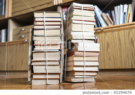 two stacks of old books tied with twine on floor two stacks of old books tied with twine on floor 85294076