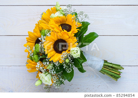 Wedding bouquet of sunflower on a wooden background. Top view with copy space. 85294854
