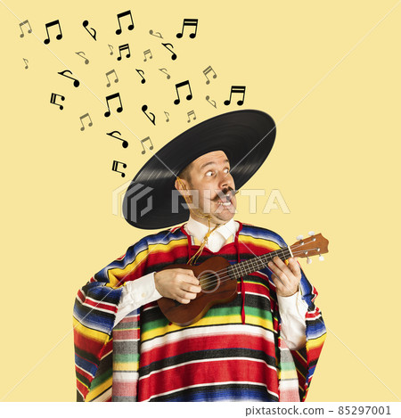 Contemporary art collage of cheerful man in mexican cloth having vinyl record sombrero playing ukulele isolated over yellow background Contemporary art collage of cheerful man in mexican cloth having vinyl record sombrero playing ukulele isolated over yellow background 85297001