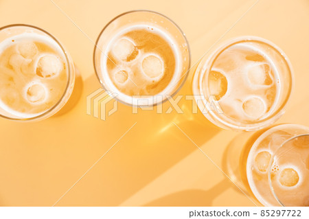 beer over yellow background beer over yellow background 85297722