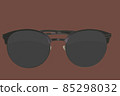 Sunglasses. Black sunglasses, close-up. Sun glasses. Old style sunglasses. Glasses with dark lenses. Vintage sun glasses on root beer color background. Close up of worn out sunglasses. Horizonatal 85298032