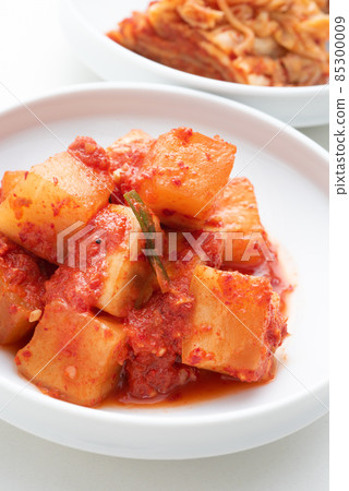 Kakuteki and kimchi served on a white plate on a white background Kakuteki and kimchi served on a white plate on a white background 85300009