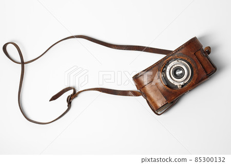 Old vintage camera with 35mm lens in brown leather case isolated on white background Old vintage camera with 35mm lens in brown leather case isolated on white background 85300132