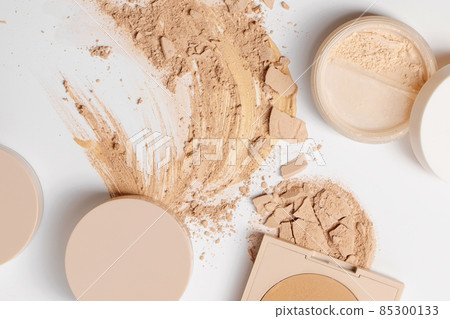 Set of make up with Crushed beige face finishing and bronzing powder on white background Set of make up with Crushed beige face finishing and bronzing powder on white background 85300133