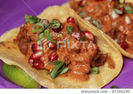 Traditional Mexican tacos with meat and vegetables in purple paper plates served for takeaway. Mexican food background. Traditional Mexican tacos with meat and vegetables in purple paper plates served for takeaway. Mexican food background. 85300290