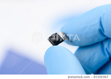 Smartphone camera module in scientist hand Smartphone camera module in scientist hand 85300367