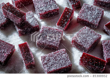 Raspberries and currant pate de fruit. Jelly, marmalade, fruit candy, covered with sugar. Raspberries and currant pate de fruit. Jelly, marmalade, fruit candy, covered with sugar. 85300932