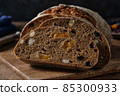 Slices of rye bread with hazelnuts and dried fruit like apricots, raisins and plums. 85300933