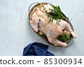 Fresh Raw chicken with herbs sage, rosemary, oregano. Top view. 85300934