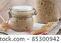 Active rye sourdough starter in a jar. Copy space. 85300942