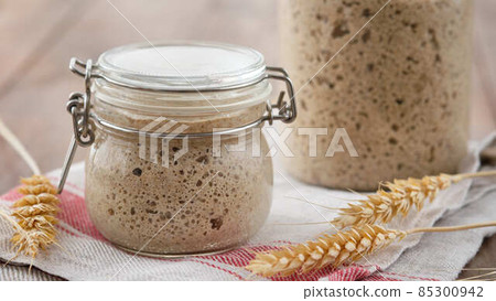 Active rye sourdough starter in a jar. Copy space. Active rye sourdough starter in a jar. Copy space. 85300942