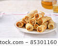 Crepes, thin pancakes with honey and tea on a white plate. 85301160