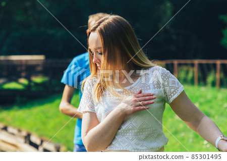 A girl walks with a guy at the edge of the lake 85301495