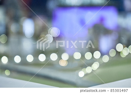 Abstraction with glare and reflection of lights and people. Blurred office green background, illuminated interior with flickering bokeh lights, modern illuminated business hall Abstraction with glare and reflection of lights and people. Blurred office green background, illuminated interior with flickering bokeh lights, modern illuminated business hall 85301497