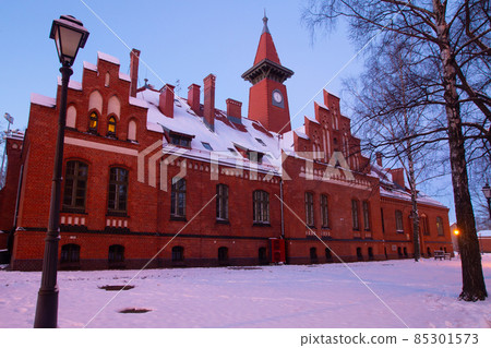 Klaipeda, Lithuania - 01 15 21: Old historical Neo-Gothic University building campus in winter snow, pink sunset colors and city lights. A fairytale atmospheric photo for postcards, touristic booklets Klaipeda, Lithuania - 01 15 21: Old historical Neo-Gothic University building campus in winter snow, pink sunset colors and city lights. A fairytale atmospheric photo for postcards, touristic booklets 85301573